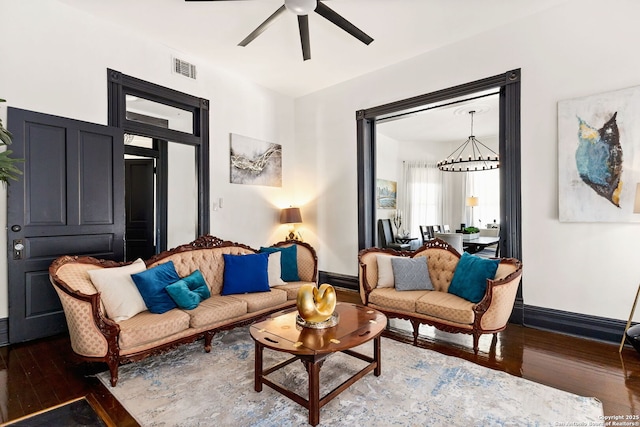 living room featuring visible vents, ceiling fan, baseboards, and hardwood / wood-style flooring