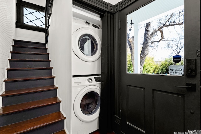 laundry area featuring stacked washer and dryer and laundry area