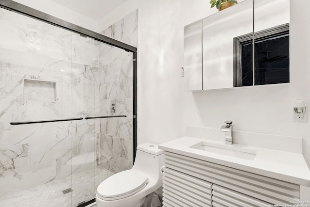 bathroom with vanity, toilet, and a marble finish shower