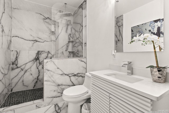 full bathroom featuring a marble finish shower, toilet, and vanity