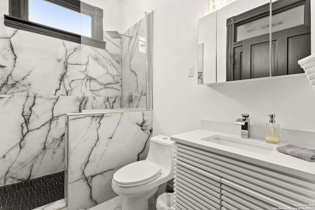 full bath featuring vanity, toilet, marble finish floor, and a marble finish shower