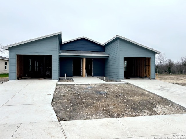 view of front of property with concrete driveway and a garage