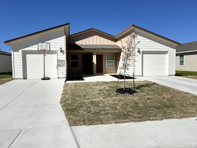 view of front facade with board and batten siding, an attached garage, and concrete driveway