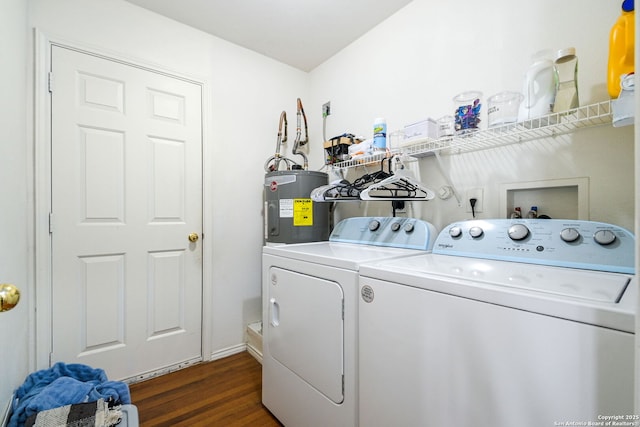 washroom with washing machine and clothes dryer, laundry area, electric water heater, and dark wood-style floors