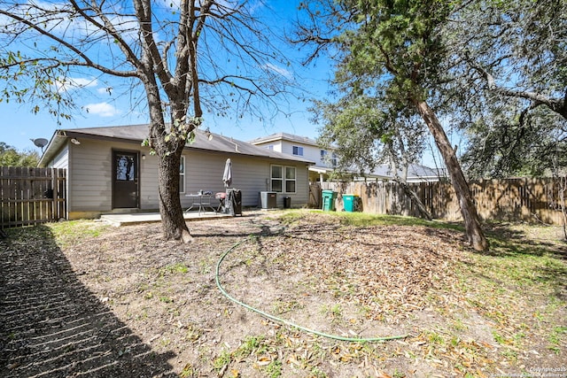 back of property with a patio and a fenced backyard