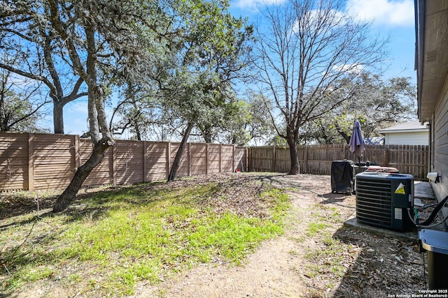 view of yard featuring central air condition unit and a fenced backyard