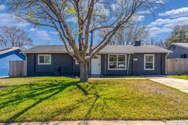 ranch-style home featuring a front lawn, fence, brick siding, and a chimney