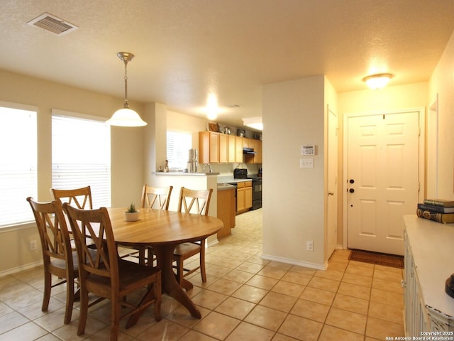 dining room with light tile patterned flooring, baseboards, and visible vents