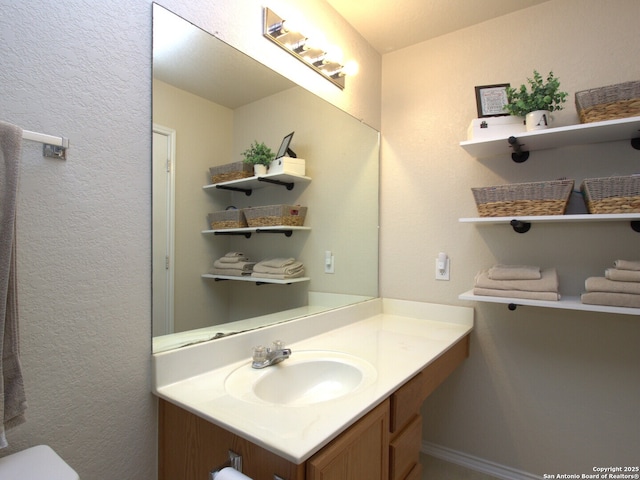 half bathroom featuring toilet and vanity