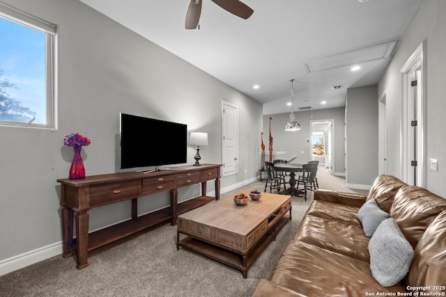 living room with baseboards, a ceiling fan, and carpet flooring