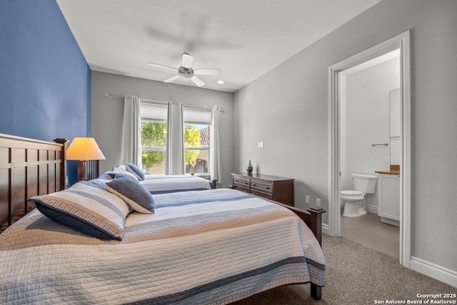 bedroom featuring ensuite bath, ceiling fan, baseboards, and carpet