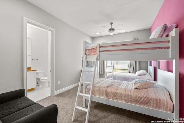 bedroom with carpet flooring, baseboards, and connected bathroom