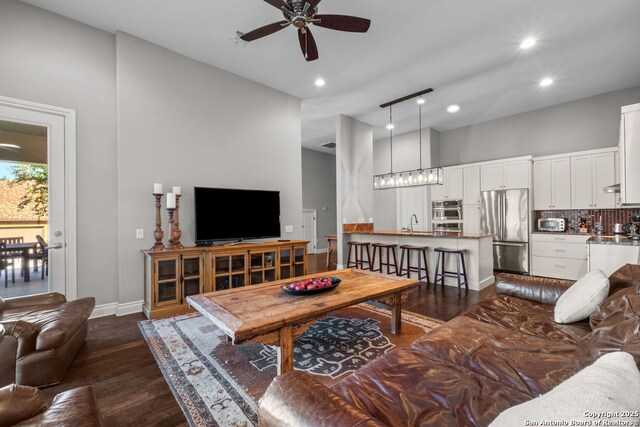 living area with baseboards, a toaster, recessed lighting, ceiling fan, and dark wood-type flooring