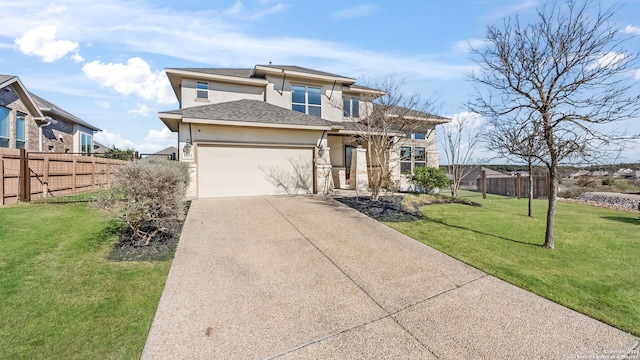 prairie-style house featuring stucco siding, driveway, fence, an attached garage, and a front yard