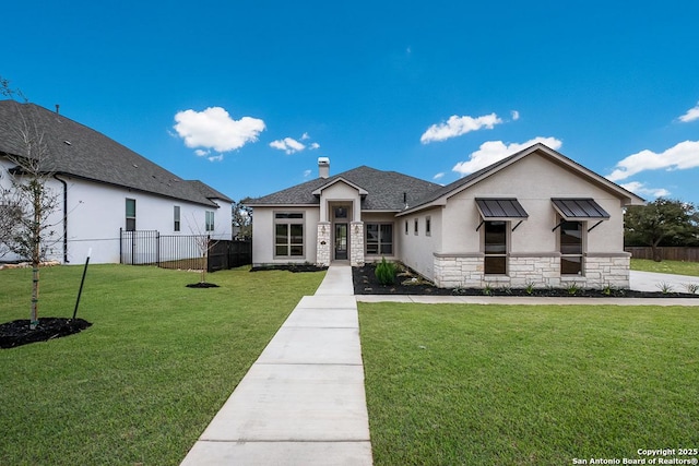 view of front of house featuring stucco siding, stone siding, a front lawn, and fence