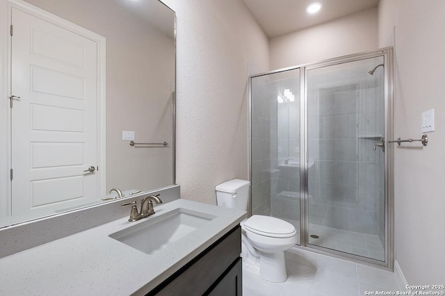 full bathroom with vanity, toilet, a shower stall, and tile patterned flooring