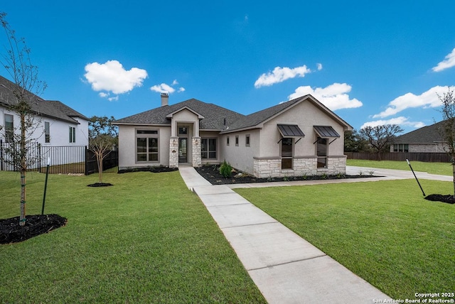 view of front of house featuring stone siding, a chimney, a front yard, and fence