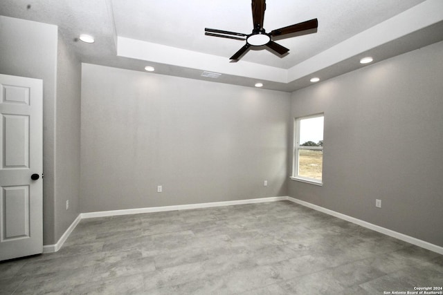 unfurnished room with a ceiling fan, baseboards, visible vents, recessed lighting, and a raised ceiling