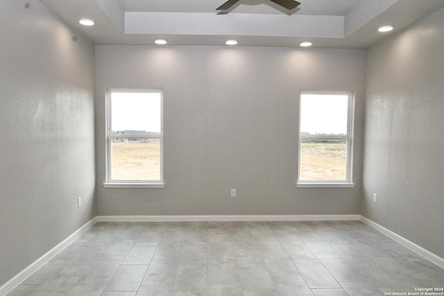 spare room with recessed lighting, a ceiling fan, baseboards, and a wealth of natural light