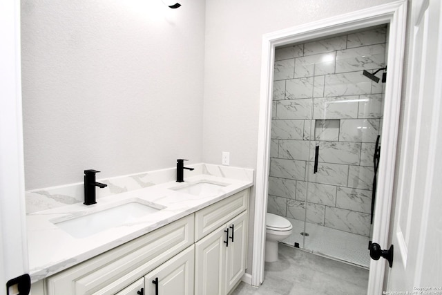 full bathroom with a shower stall, toilet, double vanity, and a sink