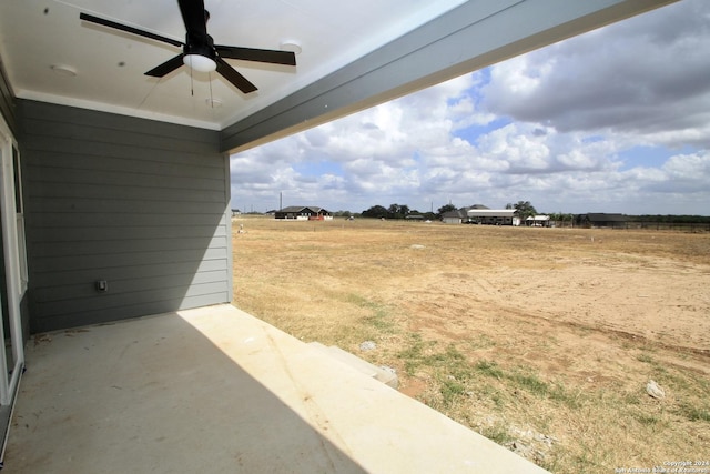 view of yard with a patio area and a ceiling fan