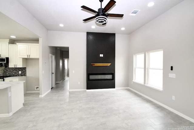 unfurnished living room with recessed lighting, visible vents, a large fireplace, and baseboards