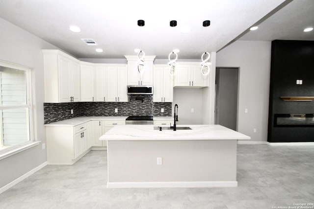 kitchen with visible vents, backsplash, light stone countertops, stainless steel appliances, and a sink