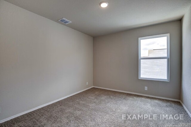7015 Comanche Cave, San Antonio, TX 78247 - spare room featuring visible vents, baseboards, and carpet flooring