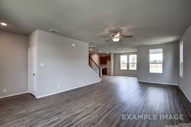 7015 Comanche Cave, San Antonio, TX 78247 - empty room featuring baseboards, visible vents, ceiling fan, stairs, and dark wood-type flooring
