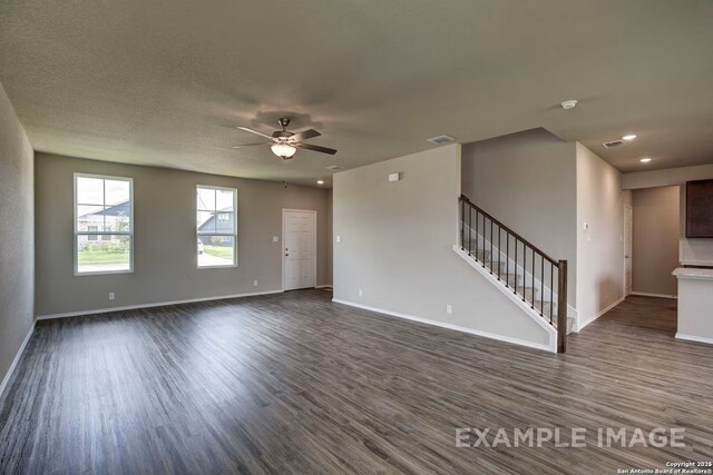7015 Comanche Cave, San Antonio, TX 78247 - unfurnished living room featuring stairs, dark wood-type flooring, visible vents, and baseboards