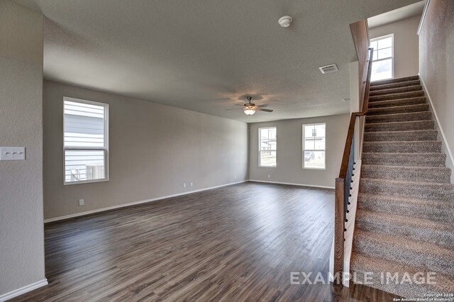 7015 Comanche Cave, San Antonio, TX 78247 - interior space with visible vents, dark wood finished floors, ceiling fan, stairs, and a textured ceiling