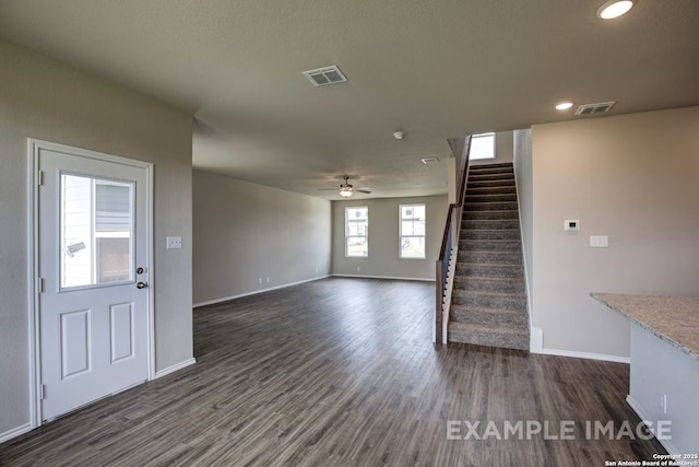 7015 Comanche Cave, San Antonio, TX 78247 - unfurnished living room featuring visible vents, dark wood finished floors, a ceiling fan, and stairway
