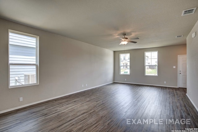 7015 Comanche Cave, San Antonio, TX 78247 - spare room featuring visible vents, baseboards, ceiling fan, and dark wood-style flooring