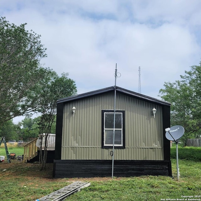 view of side of property featuring an outbuilding