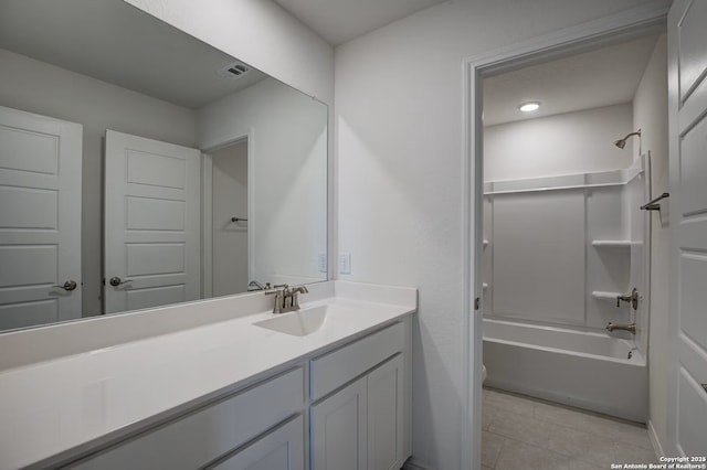 bathroom with tile patterned floors, visible vents, shower / washtub combination, and vanity