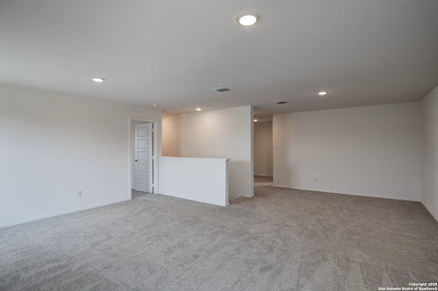 unfurnished room with recessed lighting, visible vents, and light colored carpet