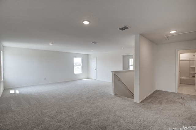 spare room featuring recessed lighting, visible vents, and light carpet