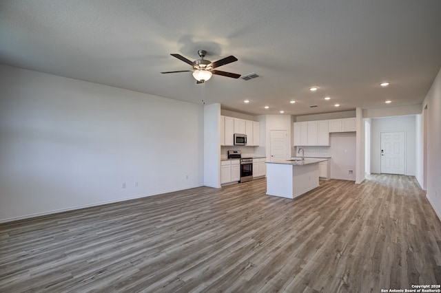 unfurnished living room with recessed lighting, visible vents, wood finished floors, and ceiling fan