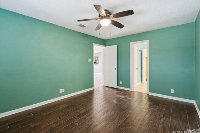 unfurnished room with visible vents, baseboards, and wood finished floors