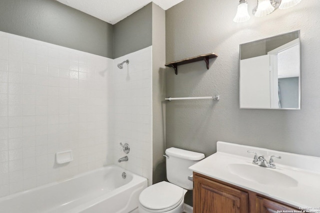 full bath featuring vanity, toilet, shower / bathing tub combination, and a textured wall