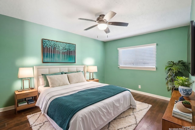 bedroom with ceiling fan, baseboards, and wood finished floors