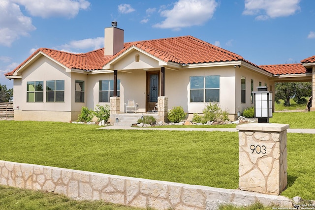 903 Panorama Pass, Horseshoe Bay, TX 78657 - view of front facade featuring a front yard, a tiled roof, and a chimney