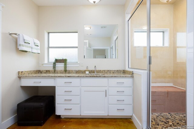 903 Panorama Pass, Horseshoe Bay, TX 78657 - bathroom with vanity, baseboards, a stall shower, and finished concrete flooring