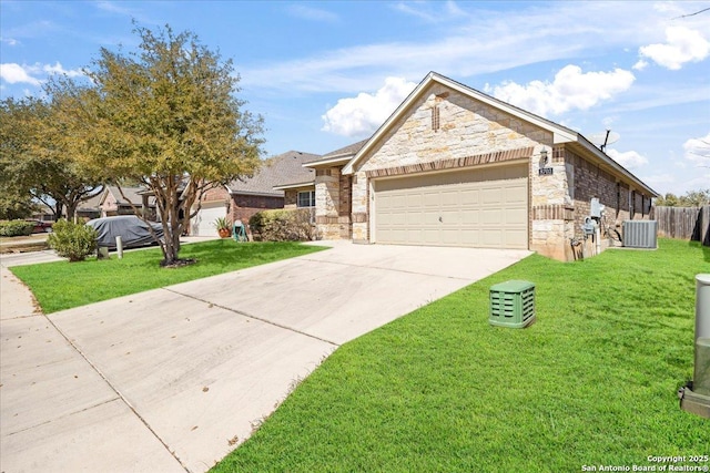 view of front of home with driveway, stone siding, central AC, a front yard, and a garage