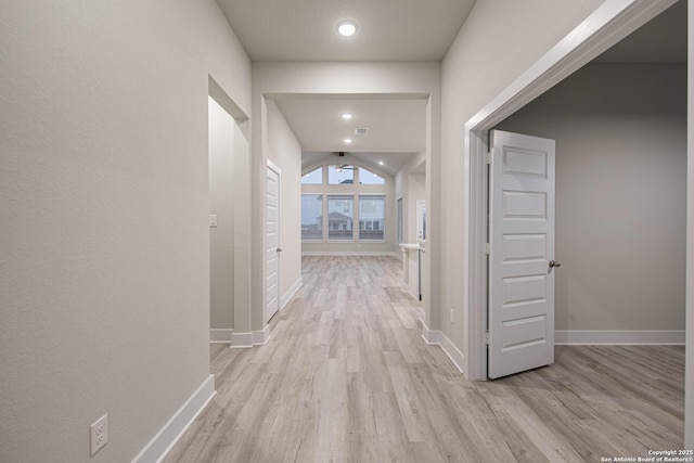 hall with light wood finished floors and baseboards