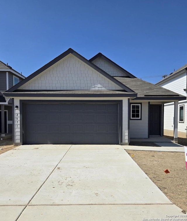 ranch-style home with concrete driveway and a garage