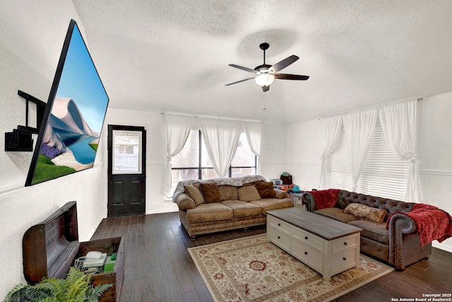 living area featuring wood-type flooring, a textured ceiling, and a ceiling fan