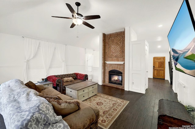 living area with ceiling fan, lofted ceiling, recessed lighting, a fireplace, and wood finished floors