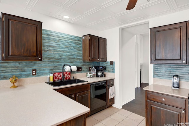 kitchen with a sink, an ornate ceiling, tasteful backsplash, light countertops, and dishwasher