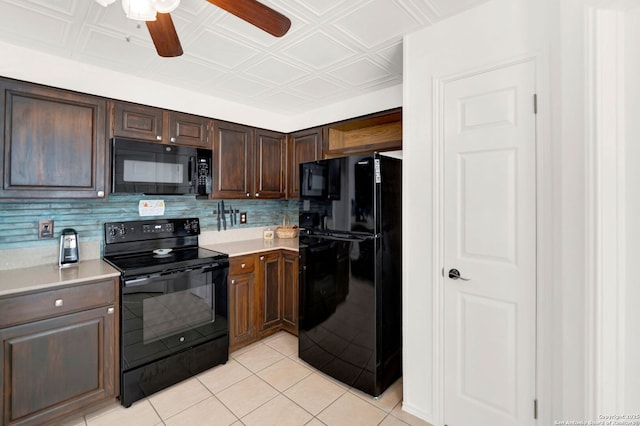 kitchen featuring light tile patterned floors, an ornate ceiling, black appliances, and light countertops